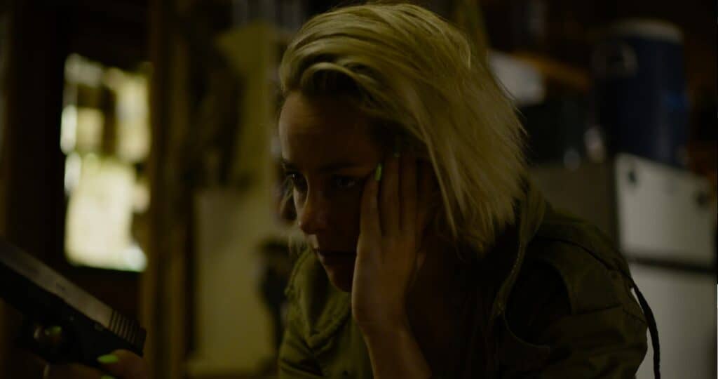 Jena Malone looks on at an impossible situation in Swallowed (2022).