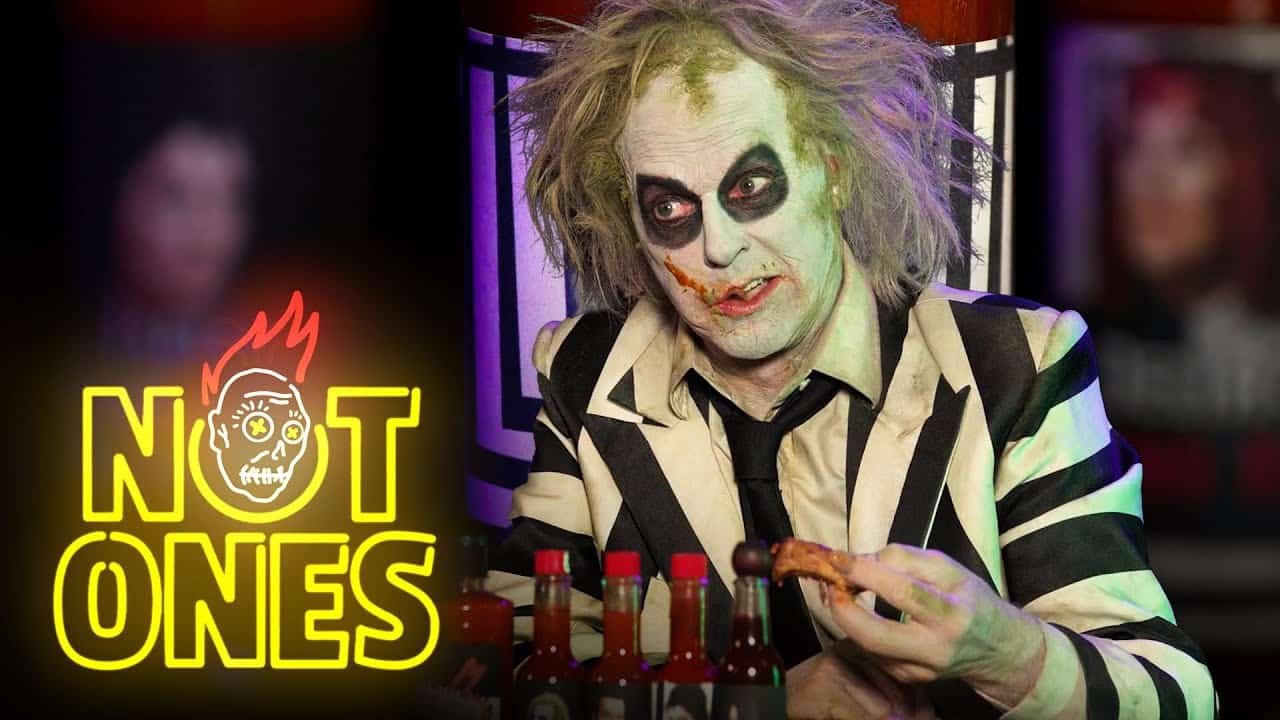 Beetlejuice sits in the hot seat for a Hot Ones parody hosted by Michael Keaton